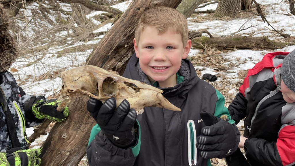 Boy holding deer skull