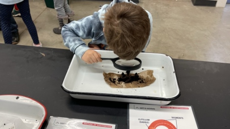 Student looking through hand lens